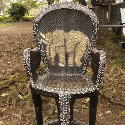 Hand-carved Bamileke Tribe King Throne Set, featuring a king's chair, foot stool, statues, and stools, symbolizing African royalty, available at BaobabMart.