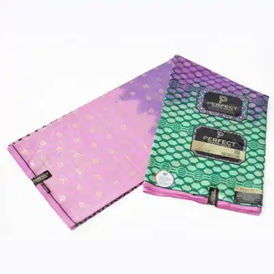 Close-up of Kente Gold Wax Fabric in Green Pink and Purple showing Kente prints